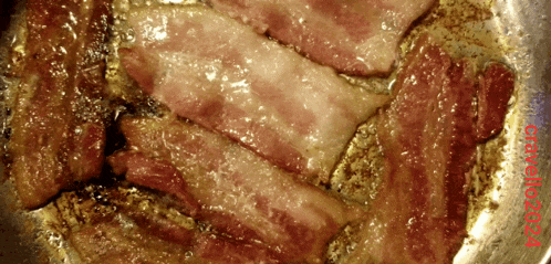 a close up of bacon in a frying pan with a red border that says cucina on it