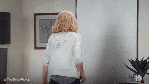 a woman is standing in front of a white door in a living room .