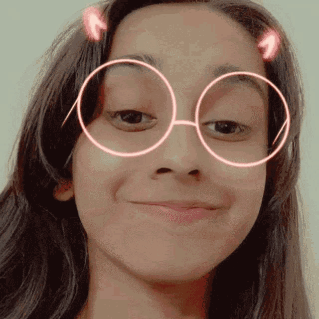 a girl wearing glasses with circles around her eyes
