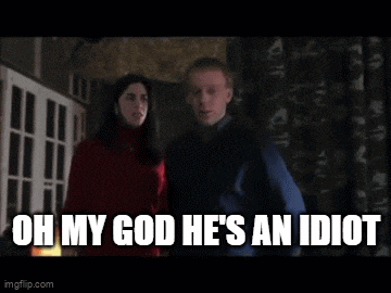 a man and a woman are standing next to each other and the man is saying " oh my god he 's an idiot "