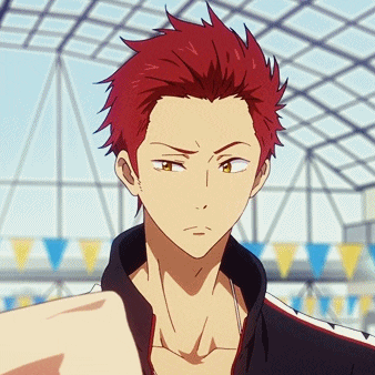 a man with red hair is standing in front of a pool