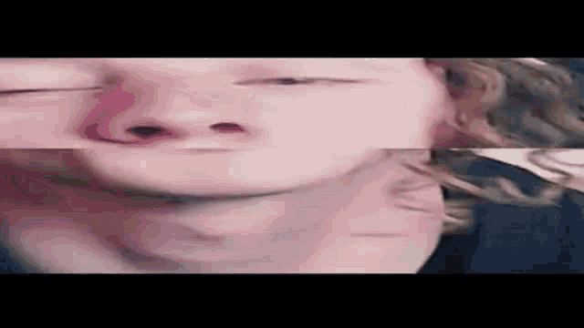 a close up of a person 's face with their eyes closed and their neck visible .