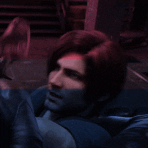 a man with a glove on his face is laying on the ground