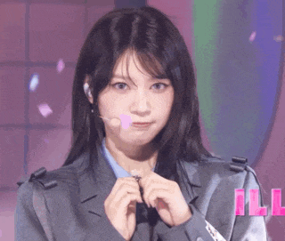 a close up of a woman wearing a suit and a microphone .