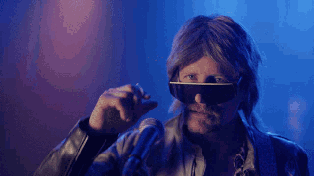 a man wearing sunglasses and a leather jacket