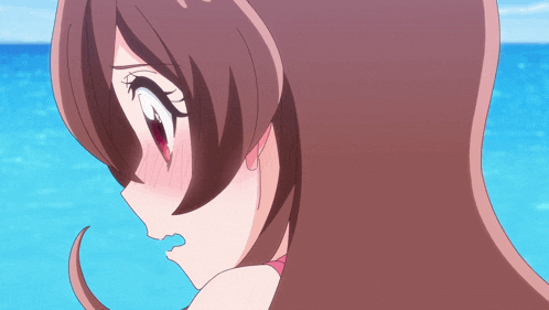 a close up of a girl 's face with her mouth open