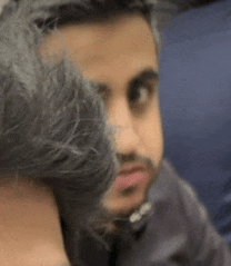 a man with a beard is hugging another man 's neck .