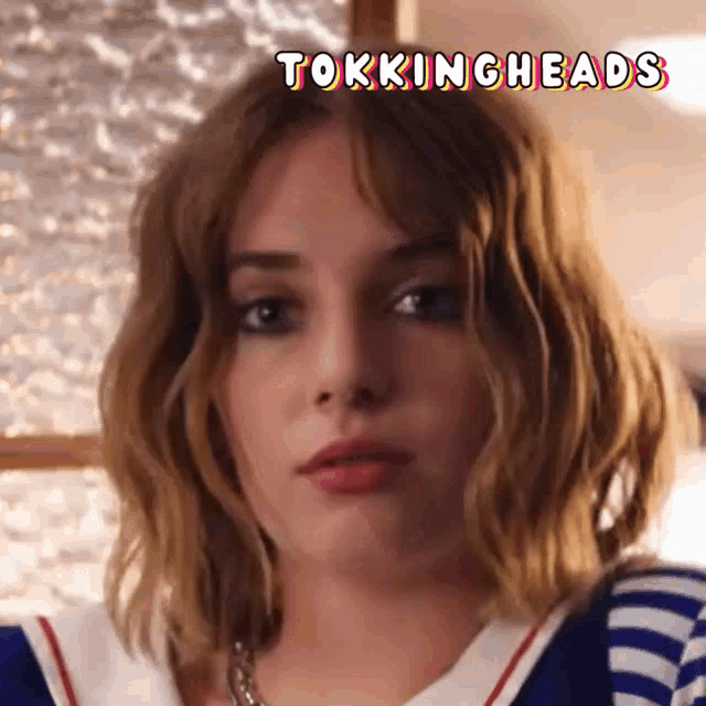 a close up of a woman 's face with the words tokingheads written above her