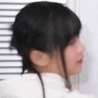 a close up of a woman 's face with a ponytail