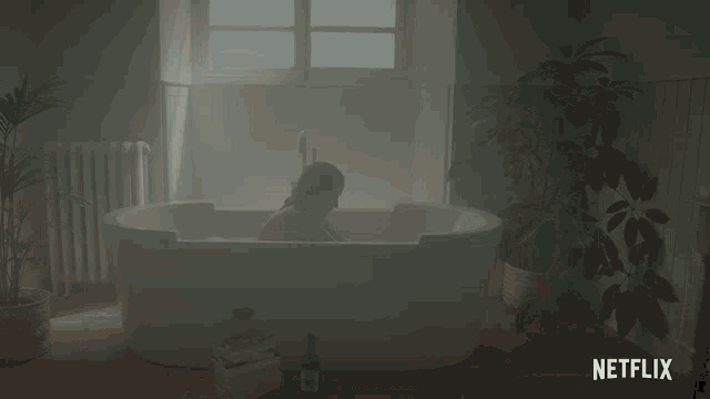 a woman is taking a bath in a bathtub that says netflix