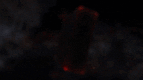a book is burning in a dark room with smoke coming out of it
