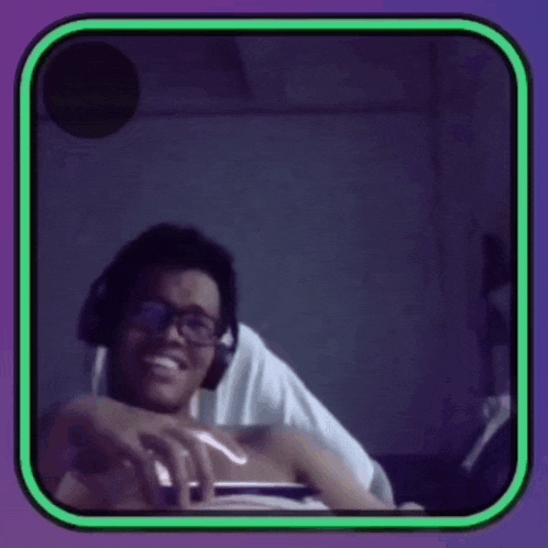 a man wearing glasses and headphones is smiling in a purple and green frame