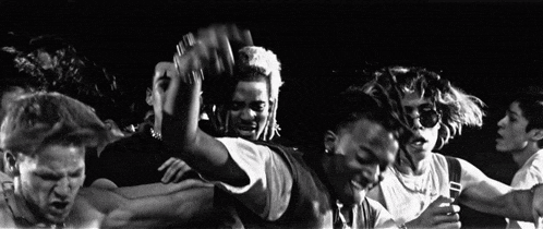 a black and white photo of a group of people with one wearing a shirt that says ' timberland ' on it