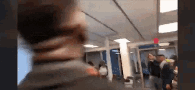 a blurry picture of a group of people standing in an airport .