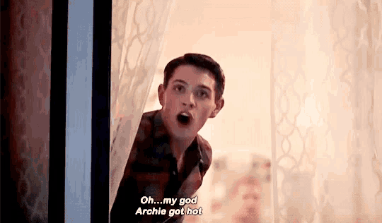 a young man is peeking out of a window and saying `` oh ... my god archie got hot ! ''