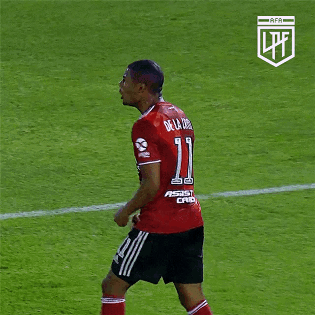 a soccer player wearing a red jersey with the number 11 on it