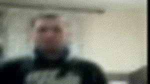 a blurry picture of a man 's face behind a glass with dots on it