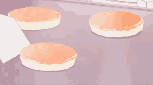 three pancakes are sitting on a tray with a purple background and the letters kc on the bottom