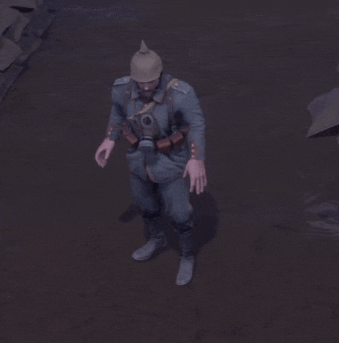 a man wearing a gas mask and a helmet is standing in the dirt .