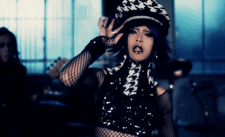 a woman wearing a hat with a houndstooth pattern on it
