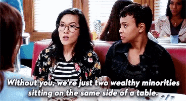 two women are sitting at a table in a diner and talking to each other