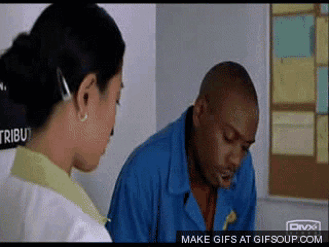 a man in a blue jacket is talking to a woman in a white shirt with the words make gifs at gifsoup.com