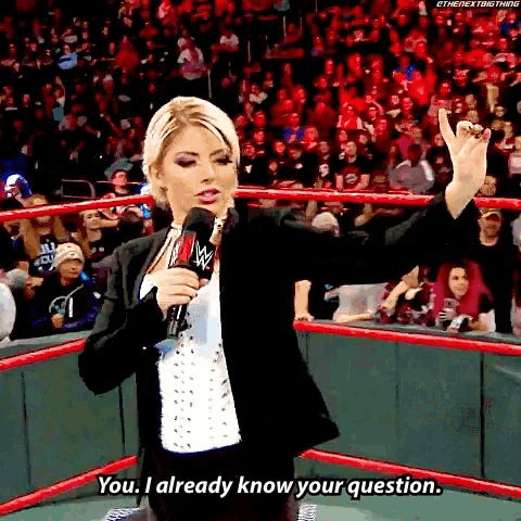 a woman in a wrestling ring talking into a microphone and saying you i already know your question