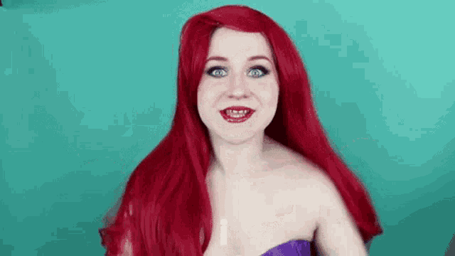 a woman with red hair is wearing a wig and making a face .