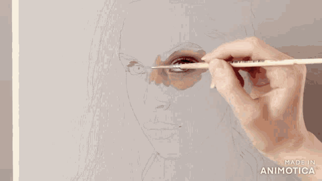 a person is painting a woman 's face with a brush and the words made in animotica are on the bottom