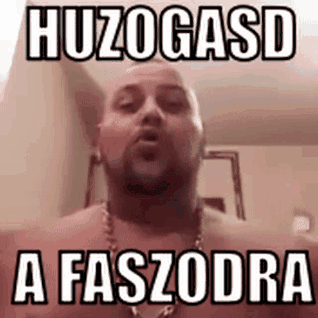 a shirtless man with a beard is making a funny face with a foreign language .
