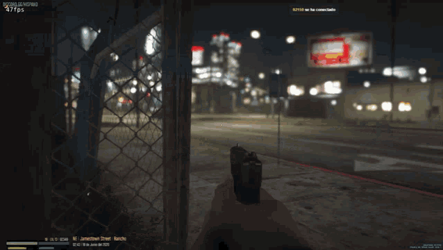 a screenshot of a video game shows a person walking behind a chain link fence at night
