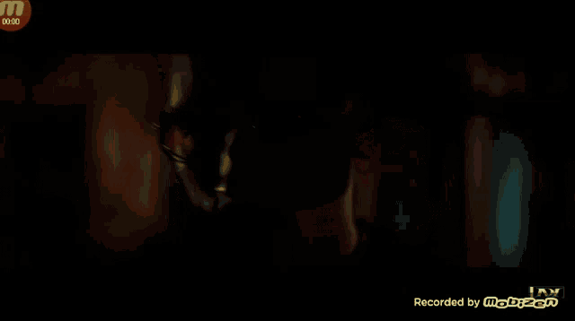 a close up of a man 's face on a screen that says recorded by mobizen