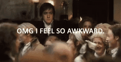 a man is standing in front of a crowd of people and says `` omg i feel so awkward . ''