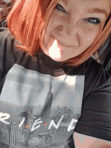 a woman wearing a black shirt that says " friends " on it