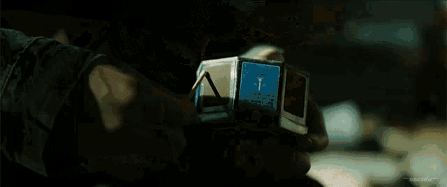 a person is lighting a match with a box of matches in their hand .
