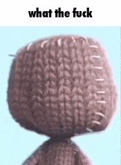 a close up of a stuffed animal 's head with the words `` what the fuck '' written above it .