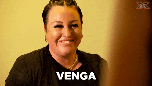 a woman is smiling with the word venga written in white