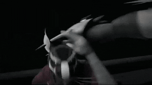 a black and white photo of a man in a mask holding a piece of paper .