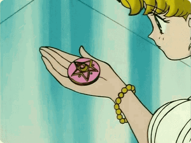 a woman is holding a pink coin with a star on it in her hand .