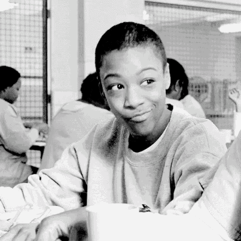 a black and white photo of a young boy smiling at the camera
