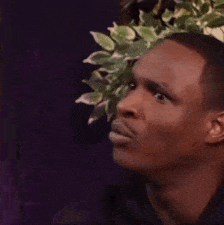 a close up of a man 's face with a purple background .
