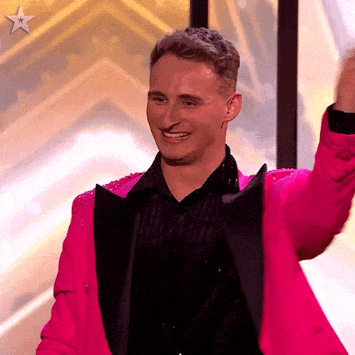 a man wearing a bright pink jacket and black shirt