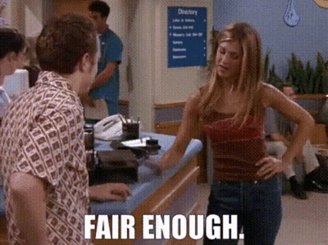 a woman standing in front of a counter with the words fair enough written on the bottom