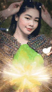 a woman in a colorful sweater is holding a green balloon in her hand .
