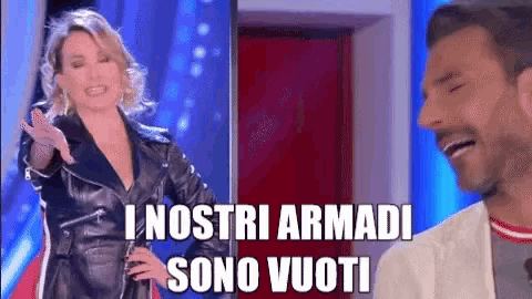 a woman in a leather jacket is standing next to a man who is laughing and says i nostri armi sono vuoti