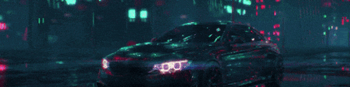 a car is driving down a wet street at night with a city in the background