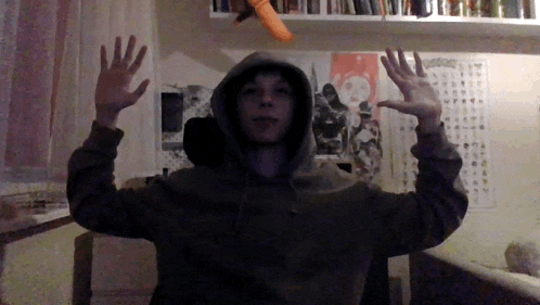 a person wearing a hoodie with their arms outstretched