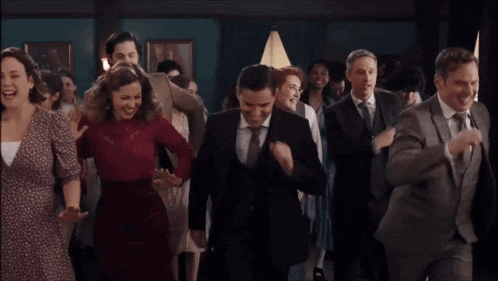 a group of people are dancing in a room