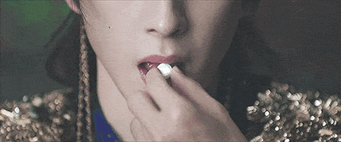 a close up of a person 's mouth with a marshmallow in it