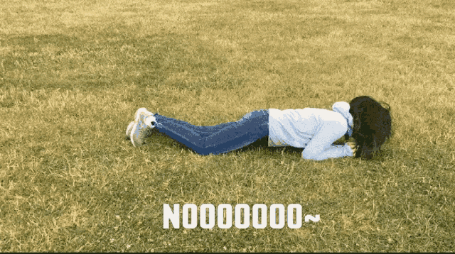 a woman laying on her stomach in a field with the words no000000 written on the bottom